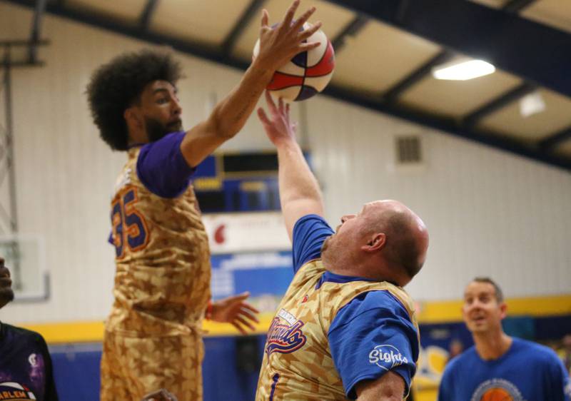 Logan Jr. High School math teacher Matt Krug, has the ball stolen from Harlem Wizards player Tyler Cronk (Sky-Rise) during the Harlem Wizards event on Tuesday, Oct. 28, 2025 in Pannebaker Gymnasium at Logan Jr. High School in Princeton.