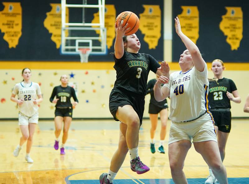 Waubonsie Valley's Maya Cobb (3) drives to the basket against Aurora Central Catholic's Ashley Watter (40) during a basketball game at Aurora Central Catholic High School on Thursday, January 30, 2025.