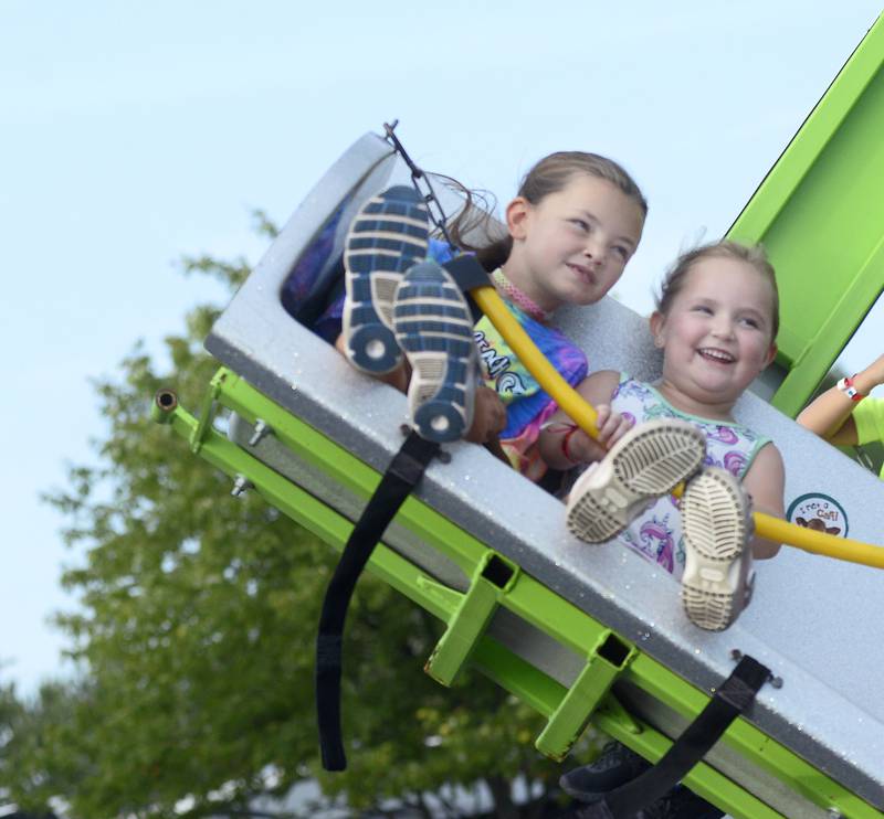 Melania Zavala and Teagan Jeffries enjoy the view Thursday, Aug. 3, 2023, while riding The Ballistic during the opening night of the Streator Fest carnival at Northpoint Plaza.
