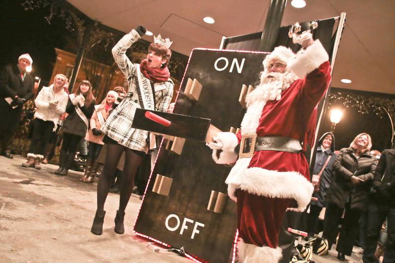 In this file photo, then-Miss Woodstock Nora Brown and Santa Claus, prepare to flip the switch and light the Woodstock square on Friday, Nov. 27, 2015.