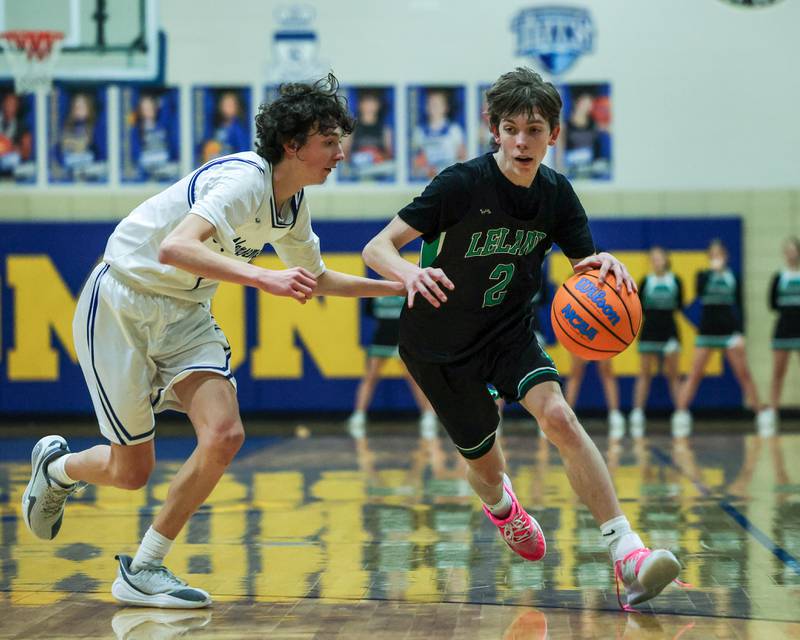 Hayden Spoonmore (2) of Leland dribbles ball down lane as Austin Reibel (1) of Newark defends during the quarterfinals of the Little Ten Conference Tournament on Monday, Feb. 2, 2026 at Somonauk High School in Somonauk.