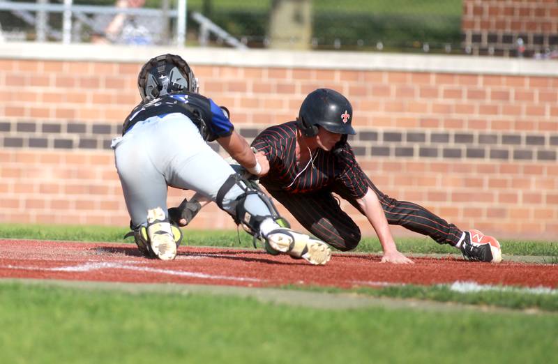 St. Charles East's Logan Frankland is tagged out at home during a game against Geneva on Tuesday, May 13, 2024 in St. Charles.