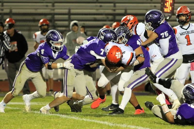 A host of Rochelle defenders tackle a Waterloo player during their game Friday, Oct. 24, 2025 in Rochelle.