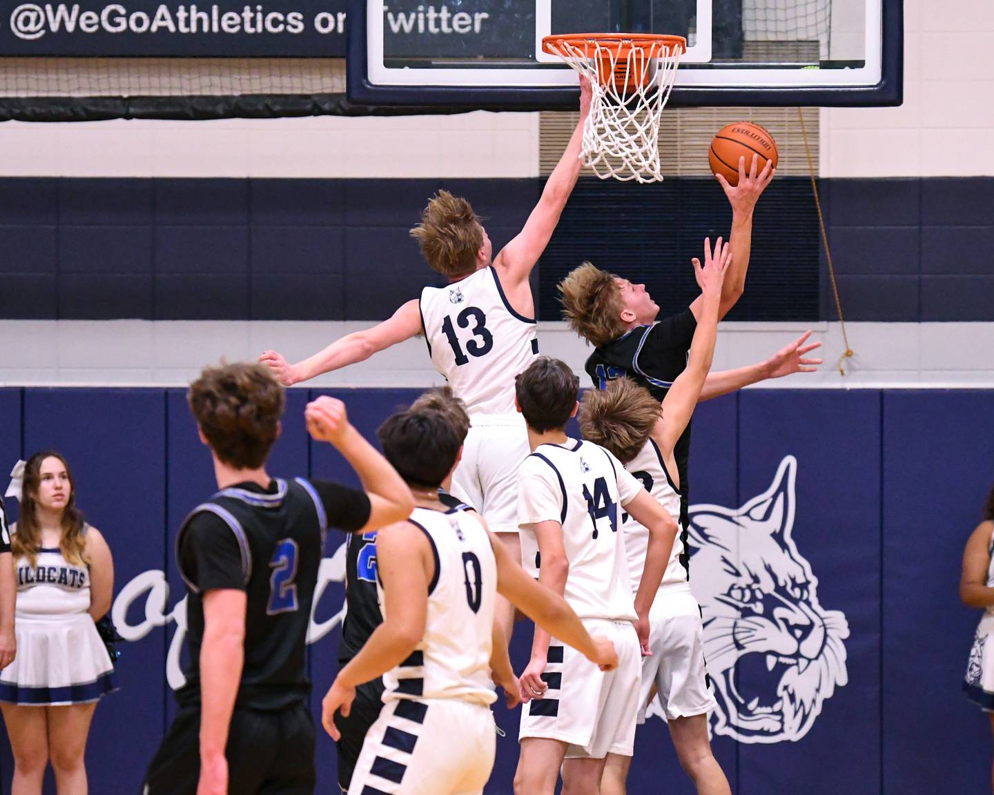 St. Charles North's Parker Reinke, center, goes up for a shot in the first quarter during the game on Tuesday Nov. 28, 2023, while being defended by West Chicago's Caleb Giannokis (13) held at West Chicago Community High School.