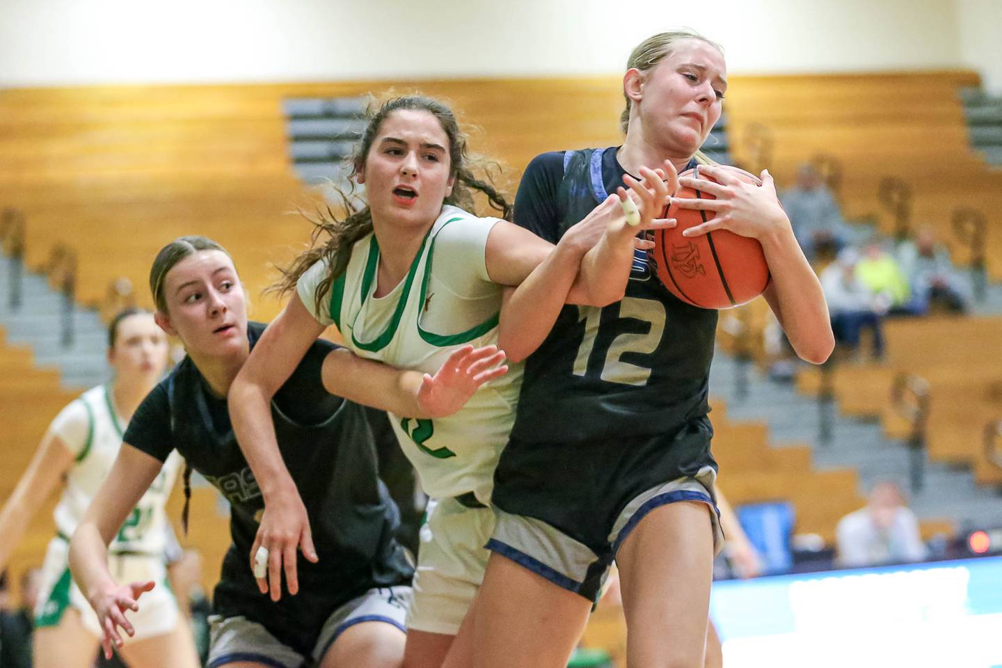 Oswego East's Nicole Warbinski (12) battles York's Lainey Portwine (12) for possession in their York Thanksgiving Tournament game between Oswego East at York on Monday, Nov 18, 2024  in Elmurst.