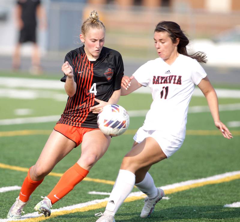 St. Charles East’s Grace Williams (left) and Batavia’s Kailey Hansen go after the ball during a Class 3A West Chicago Sectional semifinal on Tuesday, May 23, 2023.