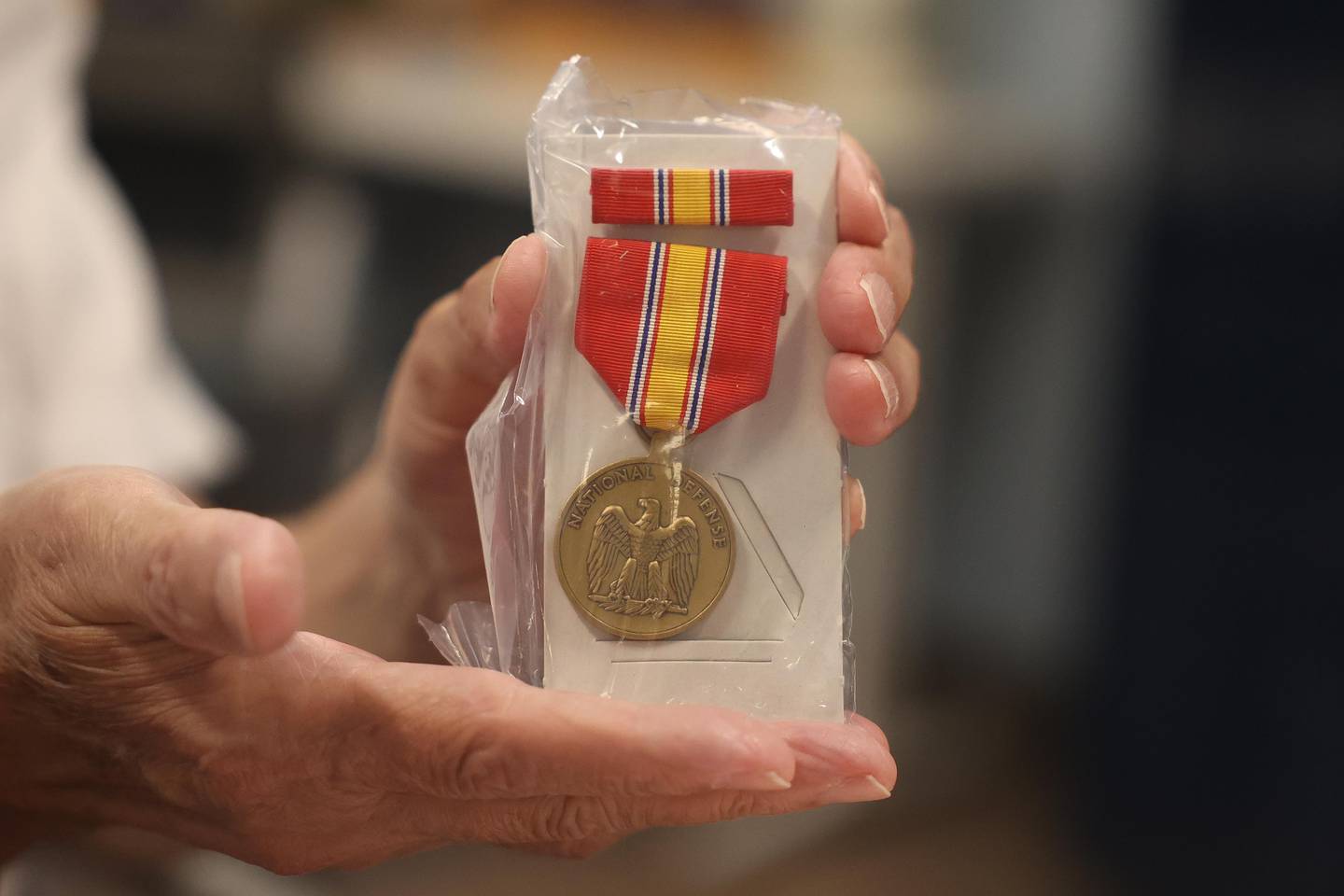 Skip Hoechbauer, veteran of the US Army, shows off a medal that he presents to veterans along with the veteran pin on Wednesday, August 14, 2024 in Joliet.