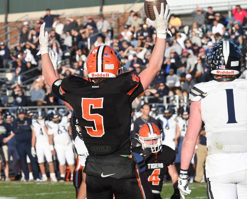 Byron's Kole Aken (5) signals the score after a touchdown against Elmhurst IC Catholic during 3A quarterfinals at Byron High School on Saturday, Nov. 15, 2025.