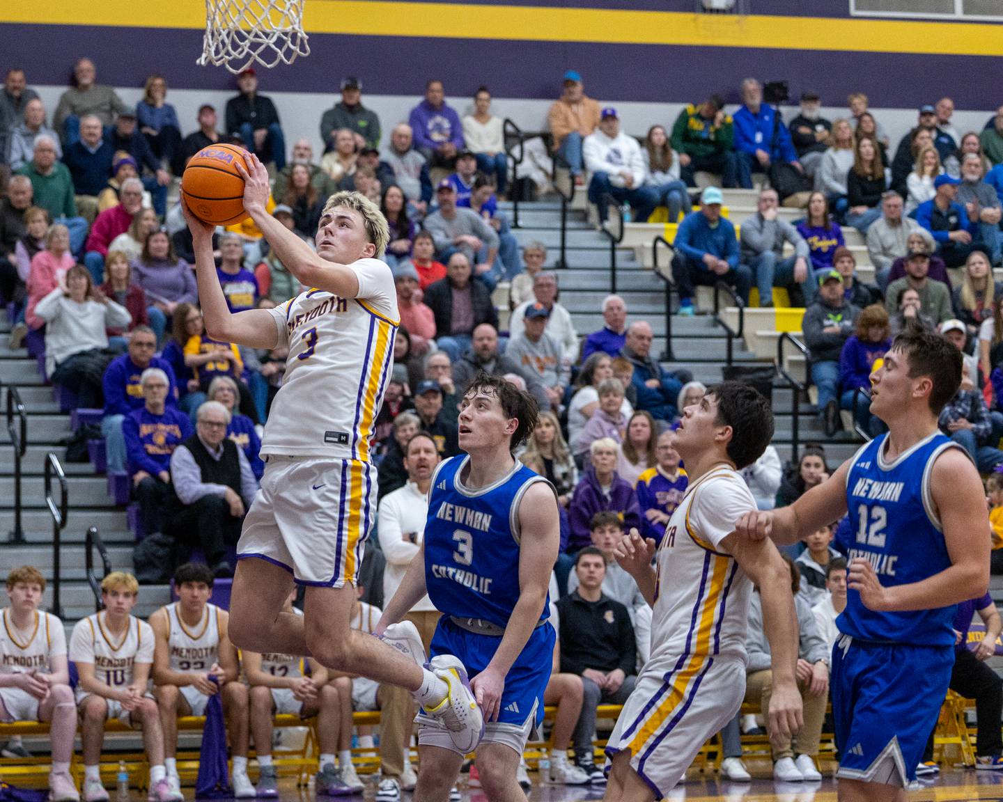 Mendota's Alex Beetz (3) leaps into layup in game against Newman Central Catholic on Friday, January 30, 2026 at Mendota High School in Mendota.