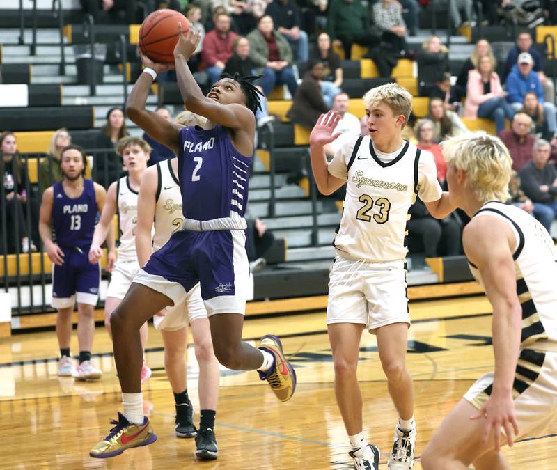 Plano's AJ Johnson gets a layup ahead of Sycamore's Carter York Tuesday, Jan. 3, 2023, during their game at Sycamore High School.
