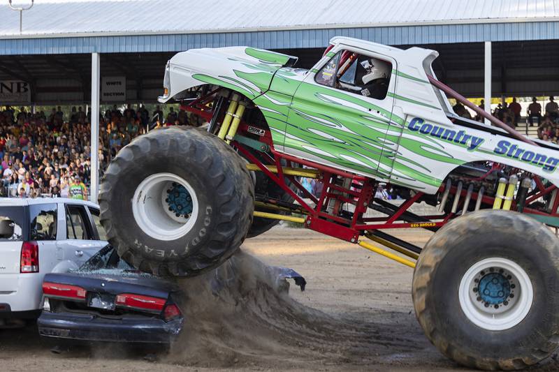 Andy Howell, driver of Country Strong, crushes his first car of the evening Thursday, August 17, 2023 during the Full Throttle Monster Truck show at the Whiteside County Fair.
