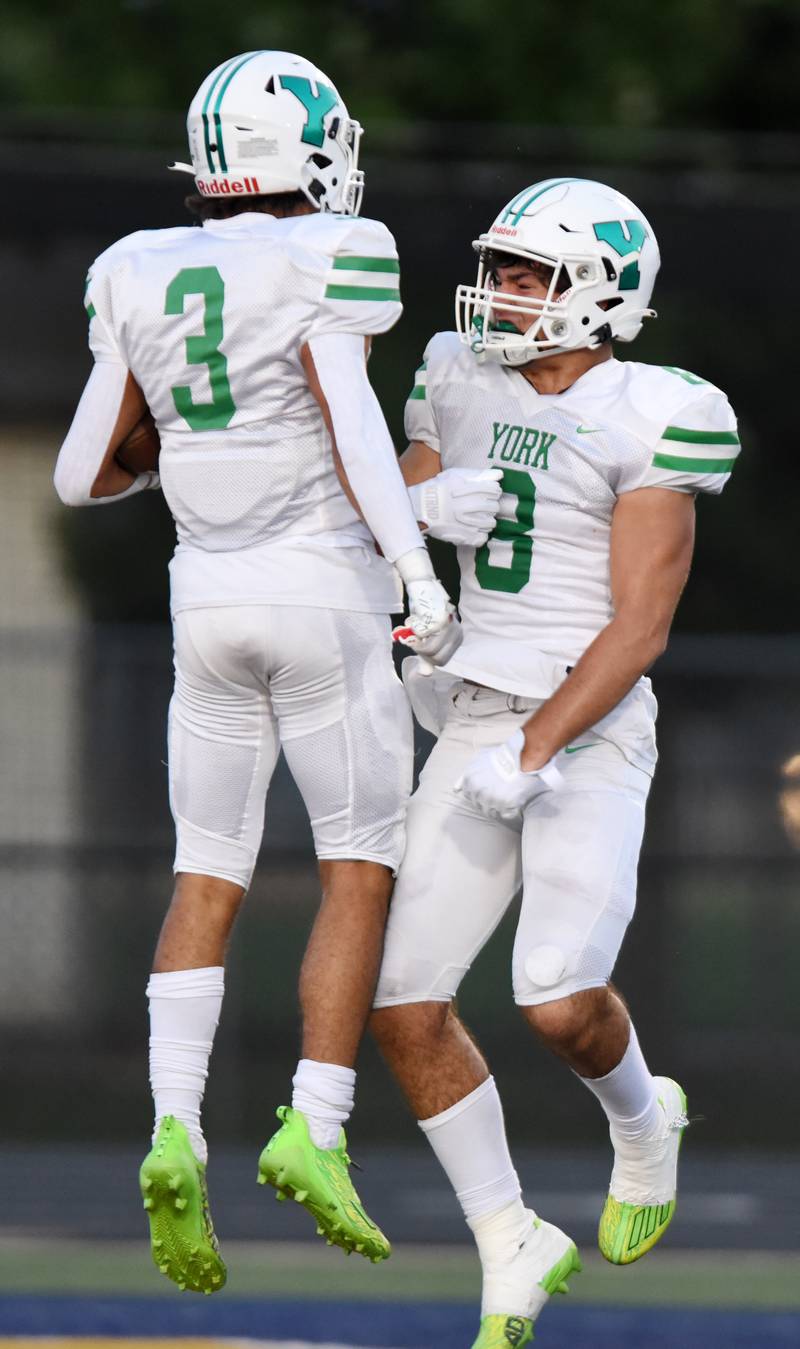 Joe Lewnard/jlewnard@dailyherald.com
York’s Chris Danko, left, celebrates a touchdown with teammate Luka Trninich during a football game against Glenbrook South, played in Glenview, Ill. on Friday, Aug. 25, 2023.