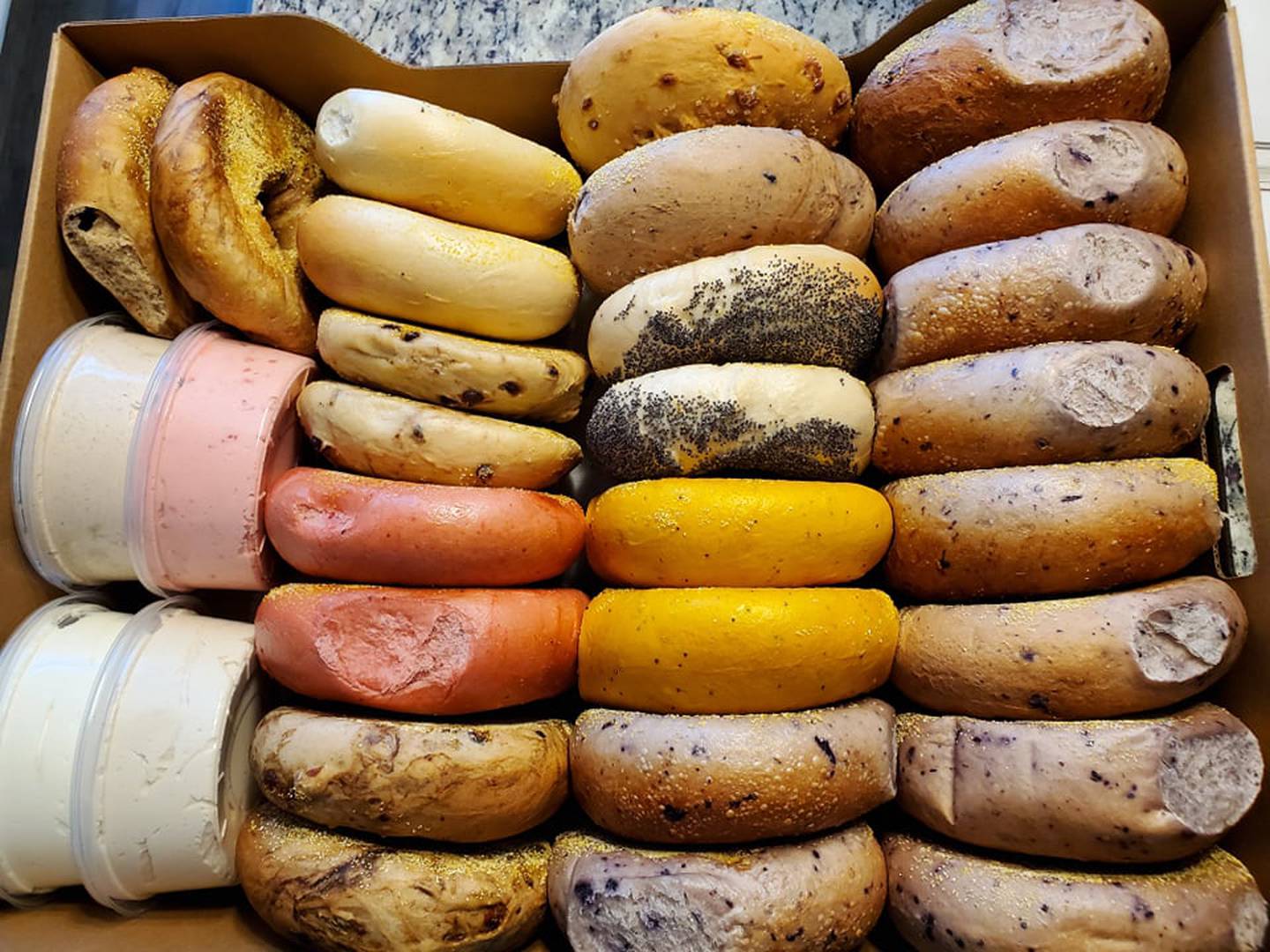 Pictured is a corporate party pack of 26 bagels from Great American Bagel in Joliet. The corporate party pack comes with four flavors of cream cheese toppings, too. We chose plain, vanilla, apple cinnamon and strawberry.
