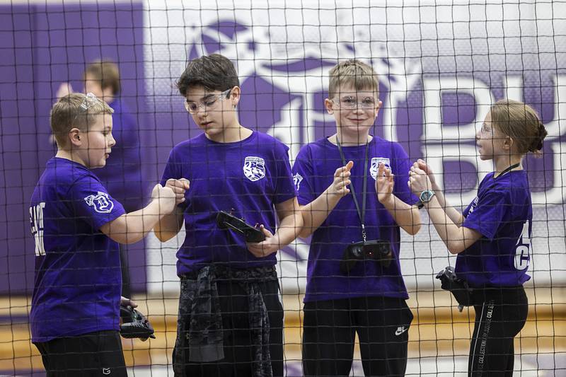 RMS Pharaohs team members Cade Kirchhoff (left), Carter Rhodes, Jacob Wendt and Lily Haws celebrate their win over their high school rivals to take the District VI championship Saturday, Feb. 24, 2024.