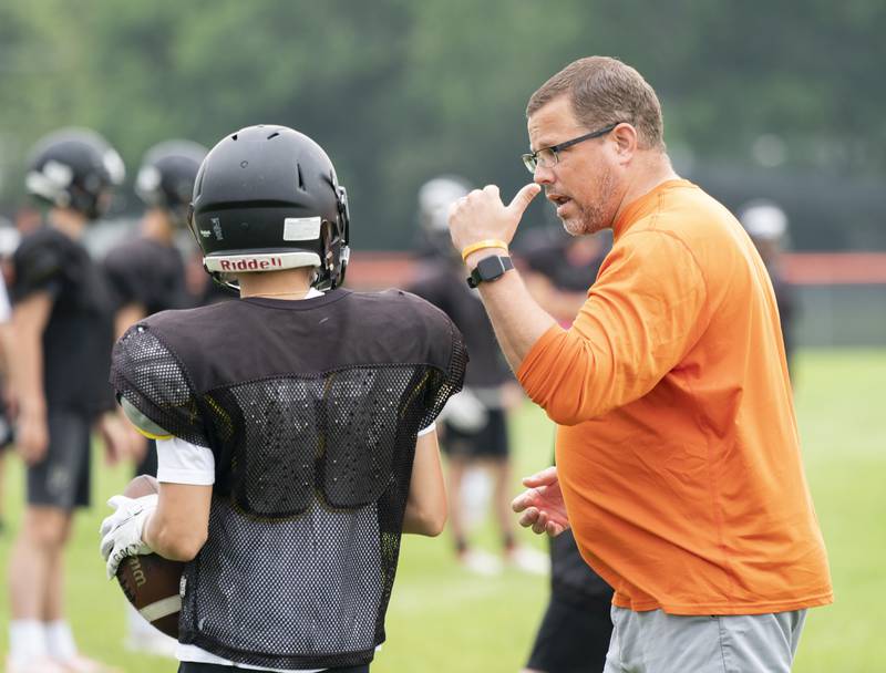 Crystal Lake Central offensive coordinator coach Dirk Stanger coaches wide receiver Casen Noennig during practice for the Crystal Lake Central varsity football team on Wednesday, July 21 at Crystal Lake Central High School in Crystal Lake.