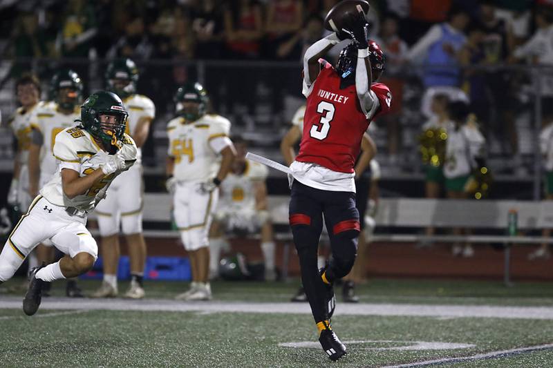 Huntley's Omare Segarra catches a pass in front of Crystal Lake South's Anthony Gountanis during a Fox Valley Conference  football game on Friday, Sept. 29, 2023, at Huntley High School. Segarra ran the ball into the end zone for a touchdown.