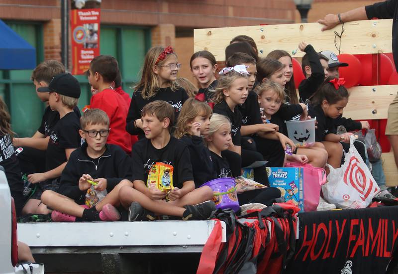 Peru Holy Family School students ride on a float during the St. Bede Homecoming parade on Friday, Sept. 27, 2024 downtown Peru.