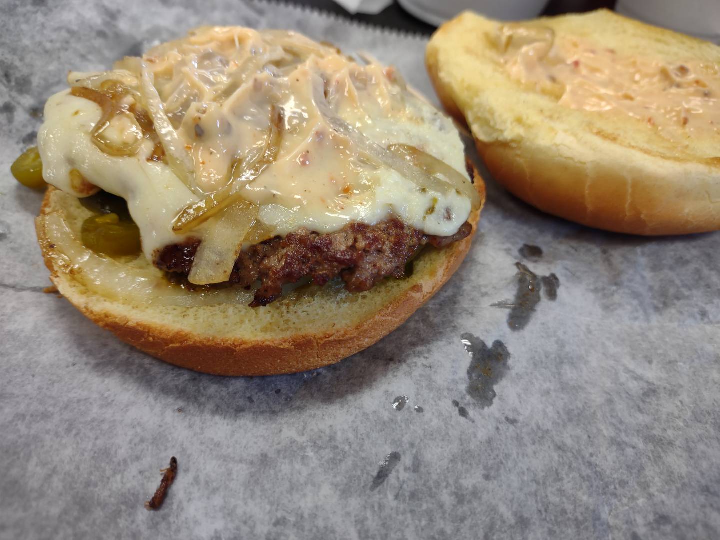 The Chipotle burger at John's Place in Peru includes pepperjack cheese, jalapeno slices, grilled onions and chipotle mayo. The flavor has mild heat.