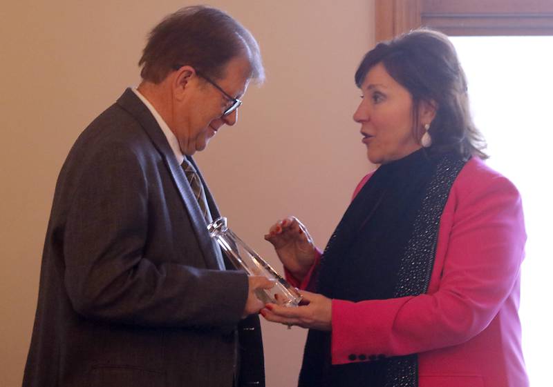 Kathleen Caldwell gives RAndy Smith his GEM award during the Crystal Lake Chamber Foundation's 11th Annual GEM Awards Leadership Celebration on April 18, 2024, at the Boulder Ridge Country Club in Lake in the Hills. This year's award winners are Elizabeth Wakeman, of Wakeman Law Group, PC.; Randy Smith, of General Kinematics Corporation; and SHAW Media/The Northwest Herald.