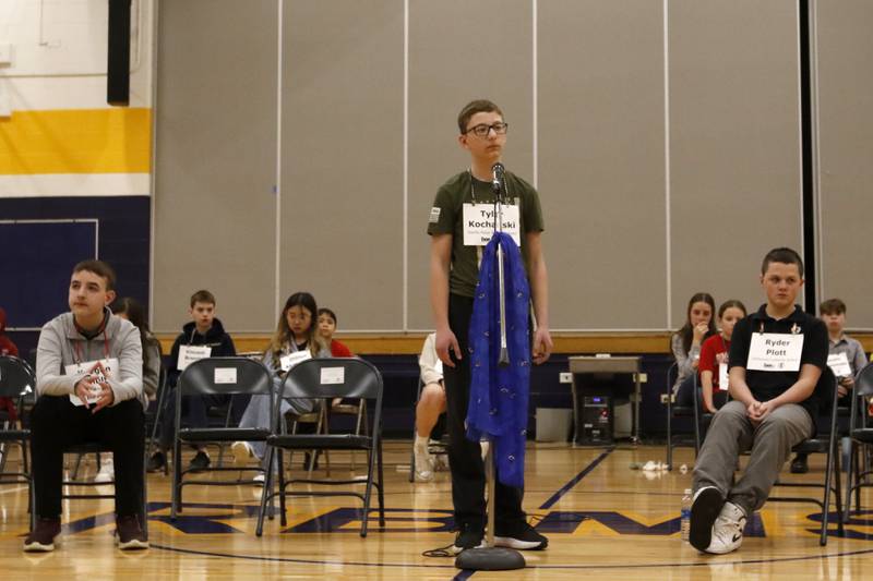 Tyler Kochanski (center), a student at Saints Peter and Paul Catholic School, waits for his word as Keegan Schultz (left), from Marengo Community Middle School and Ryder Plott from Immanuel Lutheran School look on. The three were the final spellers in the McHenry County Regional Office of Education’s 2025 Spelling Bee on Wednesday, March 19, 2025, at Bernotas Middle School in Crystal Lake.