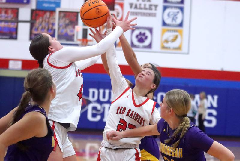 Huntley’s Maya Mangan, left, and Aubrina Adamik, right, battle for the ball against Hononegah in girls basketball at Dundee-Crown High School in Carpentersville on Tuesday, November 25, 2025.