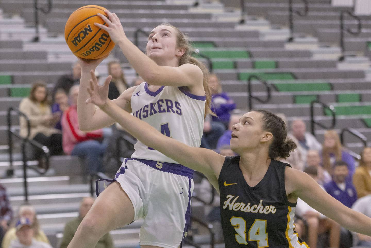 Macy Mahler of Serena High School jumps into a layup against a Herscher athlete during the Falcon-Irish Girls Basketball Tournament on November 19, 2024 at Seneca High School.