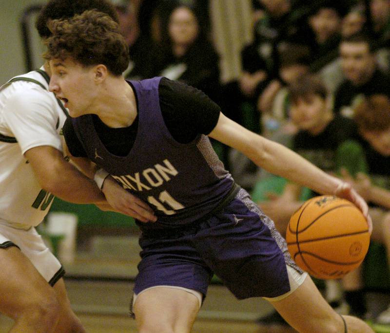 Dixon's Brody Nicklaus goes hard into Rock Fall's player Z'Viyon Martin. The Rock Falls Rockets hosedt the Dixon Dukes in a Conference basketball game. The game was held at Forest Tabor gym in Rock Falls on Friday, February 13, 2026