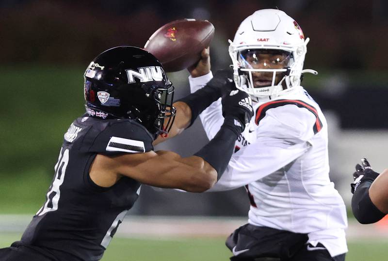 Northern Illinois' Nevaeh Sanders grabs Ball State quarterback Kiael Kelly during their game Tuesday, Nov. 7, 2023, in Huskie Stadium at NIU in DeKalb.