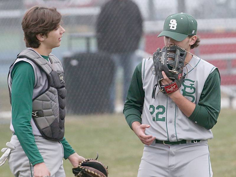 St. Bede catcher Nathan Husser talks to pitcher Alan Spencer while facing Ottawa on Wednesday, March 22, 2023 at Ottawa High School.