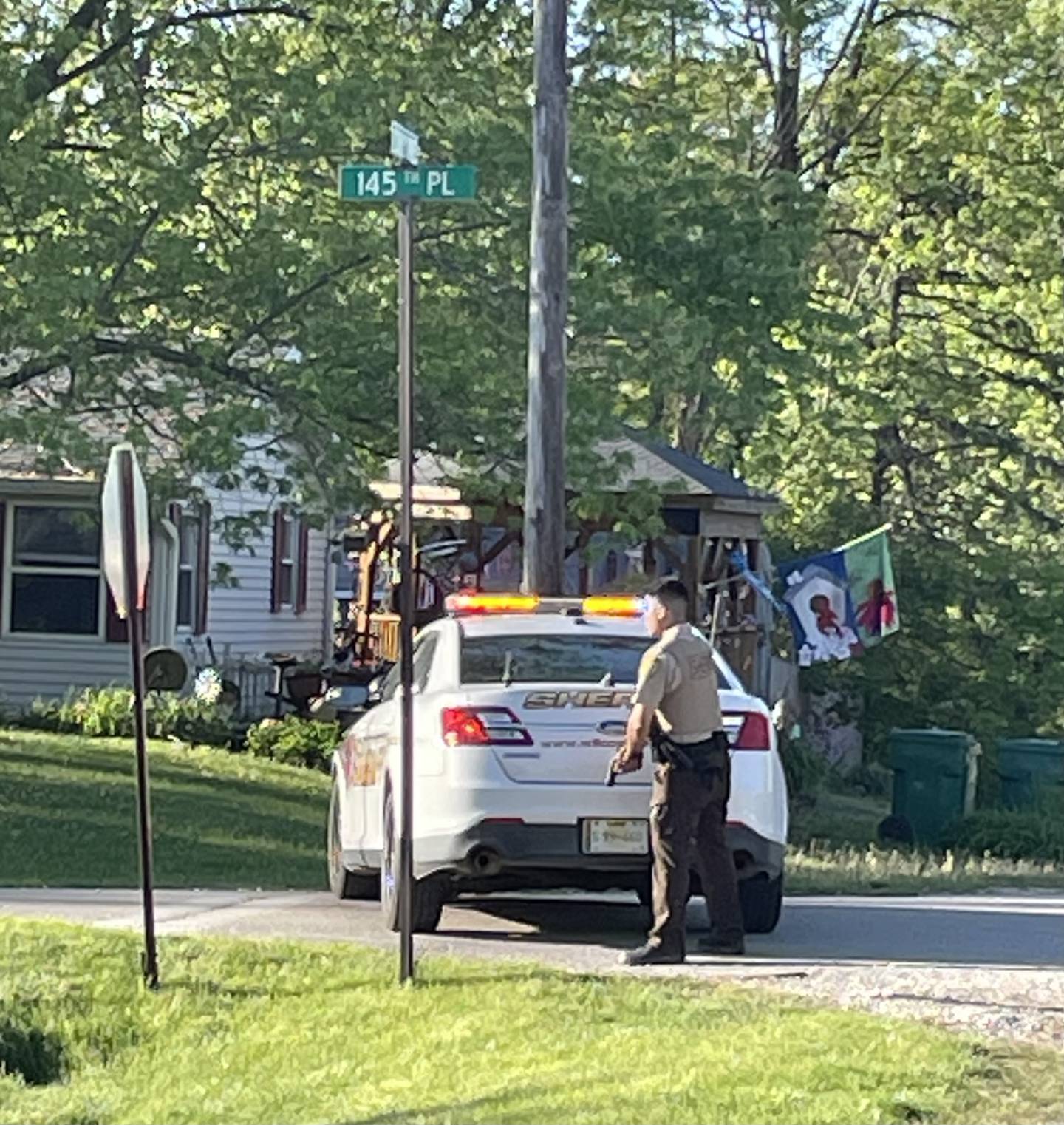 A Will County sheriff's deputy guards the intersection of 145th Place and S. 136th Avenue in the Lockport Heights neighborhood the evening of Tuesday. May 7, 2024.   Both Will County and Lockport police were at the scene.