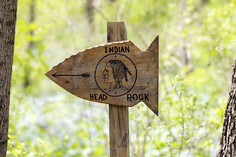 A signpost points the way to the Indian Head carving. New trails were added to make passage to the work accessible.
