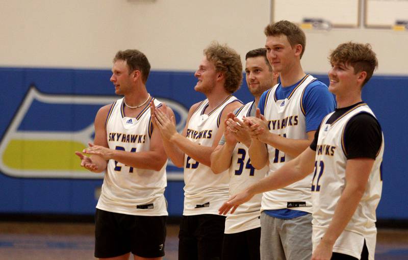 Johnsburg Skyhawks from through the years gather before an alumni basketball game against the McHenry Warriors at Johnsburg High School Saturday evening to benefit the family of Jackson Werderitch, a 10-year-old who was struck by a car.