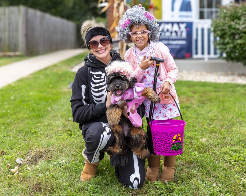 Kalena Foust with her daugher Kylie and dog Waffles enjoy the Plainfield Spooktacular Trick-or-treating event Saturday Oct 25, 2025 in Plainfield.