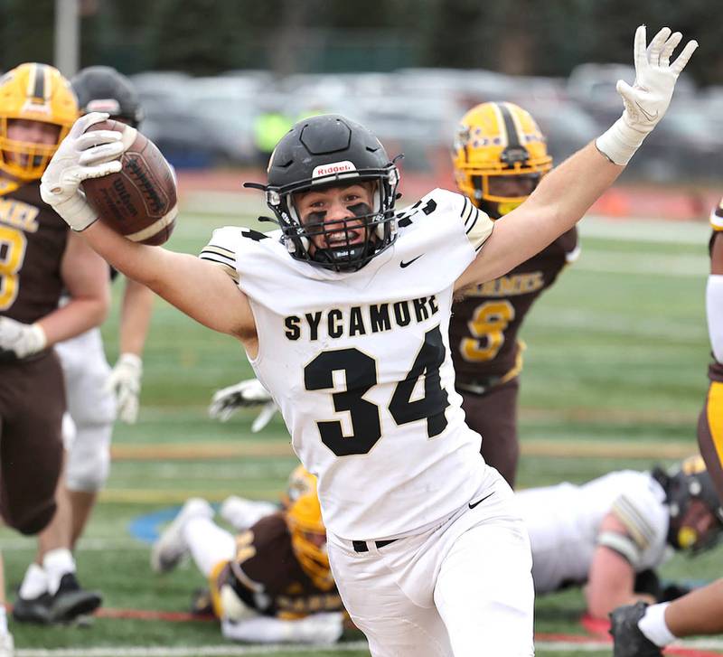 Sycamore's Joey Puleo celebrates after scoring the first touchdown of the contest during their Class 5A second round playoff game against Carmel Saturday, Nov. 5, 2022, at Carmel Catholic High School in Mundelein.