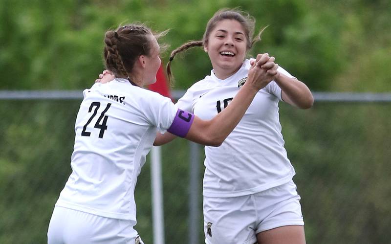 Sycamore's Mariana Martinez is congratulated by teammate Ella Shipley after scoring a goal during their IHSA Class 2A regional game against Woodstock North Tuesday, May 17, 2022, at Burlington Central High School.