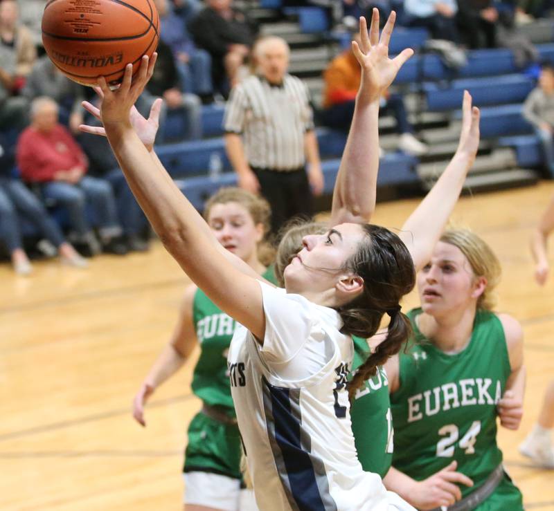 Fieldcrest's Ashlyn May runs into the lane to score a basket over Eureka defenders on Monday, Jan. 9, 2023 at Fieldcrest High School.