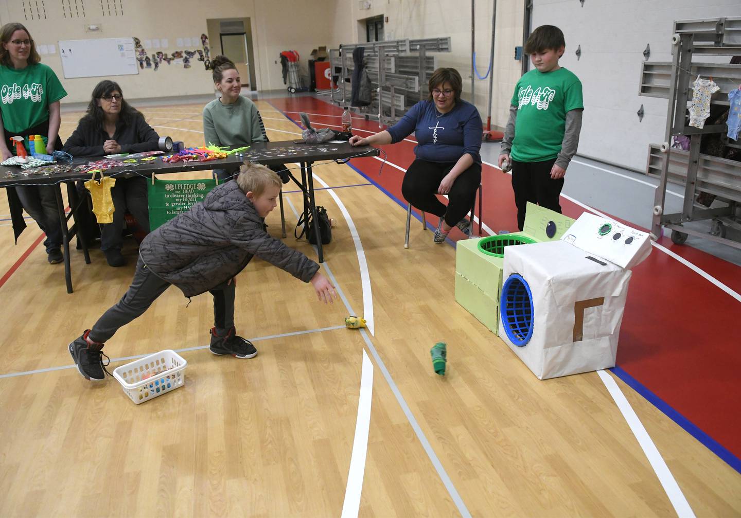 Wyatt Frewin, 6, of Oregon, tosses a sock into a cardboard washer at the 4-H Penny Carnival on Saturday, March 18 at the the Blackhawk Center in Oregon. The Ogle County Clovers 4-H Club offered this game for participants.