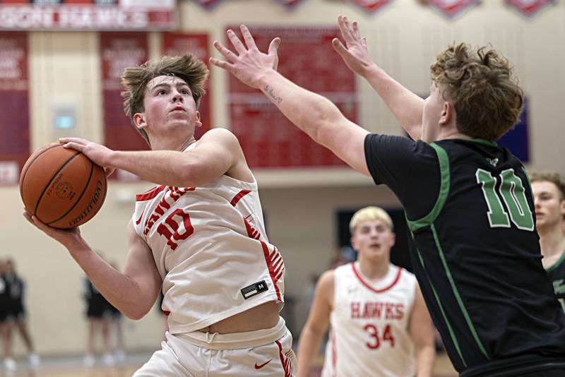 Oregon’s Keaton Salsbury puts a shot up against Rock Falls’ Kuitim Heald Tuesday, Dec. 12, 2023 in Oregon.