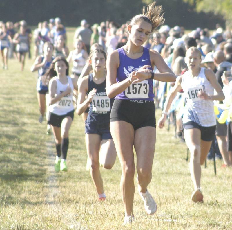 Fourth place finisher  Daniela Lovett checks her watch after her finish. Local High School teams gathered at Hoover Park in Sterling for the Rock River Run, held on Saturday, September 27, 2025.