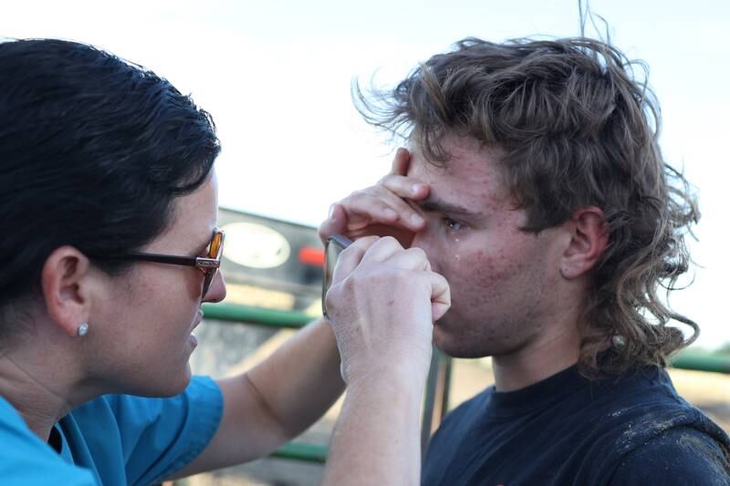 Dominic Dubberstine-Ellerbrock gets checked for a concussion by his mother, Candice, after getting thrown and trampled by a bull during practice. Dominic will be competing in the 2022 National High School Finals Rodeo Bull Riding event on July 17th through the 23rd in Wyoming. Thursday, June 30, 2022 in Grand Ridge.