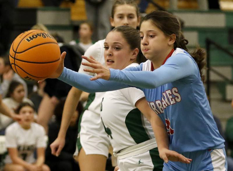 Marian Central's Elva Fallaw (right) tries to save the basketball in front of Grayslake Central's Annie Wolff during a nonconference girls basketball on Monday, Jan. 13, 2025, at Grayslake Central High School.