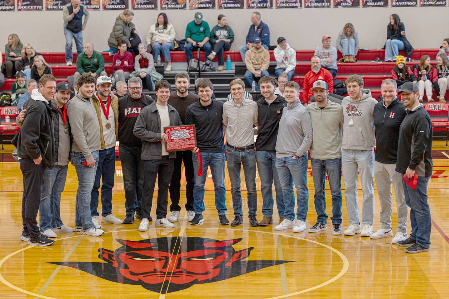 Hall Red Devils 2018 2A State Champions pose for photo at the 2026 Hall High School Hall of Fame ceremony on Saturday, January 31, 2026 at Hall High School in Spring Valley. Players inducted include Chance Resetich, Brayden DeBates, Cole Wozniak, Christian Stefaniak, Cam McDonald, Sean Riordan, Conner Ripka, Ty Rybarczyk, James Mautino, Matt Hultz, Payton Plym, Devin Soldati, Grant Resetich, Trez Rybarczyk, Jimmy DeAngelo, Gunner McCormick, Brant Vanaman, and Alec Bulak with coaches Tom Keegan, Matt McDonald, Kevin Sangston, Randy Tillman and Rhodes Garland.
