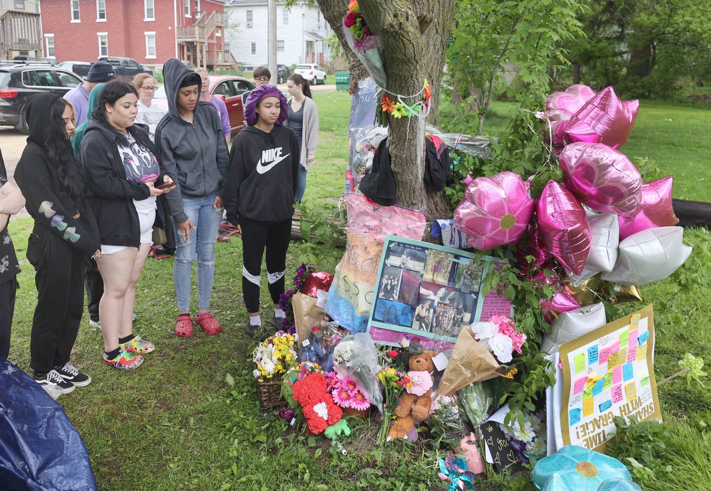 Visitors and friends gather to pay their respects during a memorial for slain Gracie Sasso-Cleveland Friday, May 12, 2023, behind a building in the 500 block of College Avenue in DeKalb.