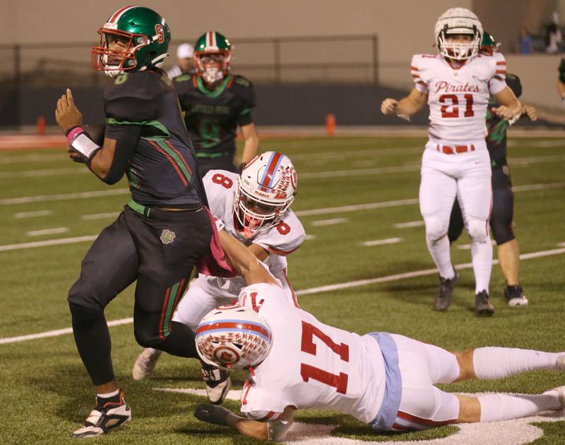 L-P quarterback Marion Persich tries to break free of Ottawa defenders Bryson Valdez and Owen Sanders on Friday, Oct. 3, 2025 at Howard Fellows Stadium.