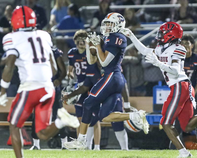 Oswego's Mariano Velasco (10) comes down with a catch near the sidelines during football game between Bolingbrook at Oswego Friday, Sept 12, 2025  in Oswego.