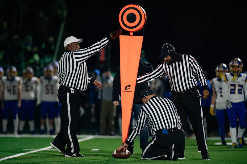 The officials measure the play resulting in a Coal City first down during the first round IHSA class 4A playoffs on Friday Nov. 1, 2024 at Coal City High School
