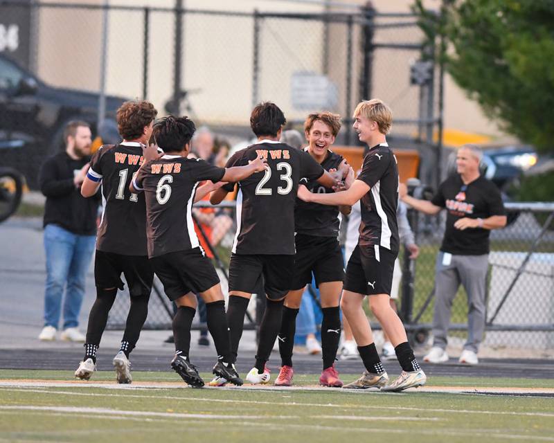 Wheaton Warrenville South's Semin Razman, second from right, is all smiles while getting congratulated by teammates after scoring a goal in the game against Wheaton North on Thursday Sept. 11, 2025, held at Wheaton Warrenville South.