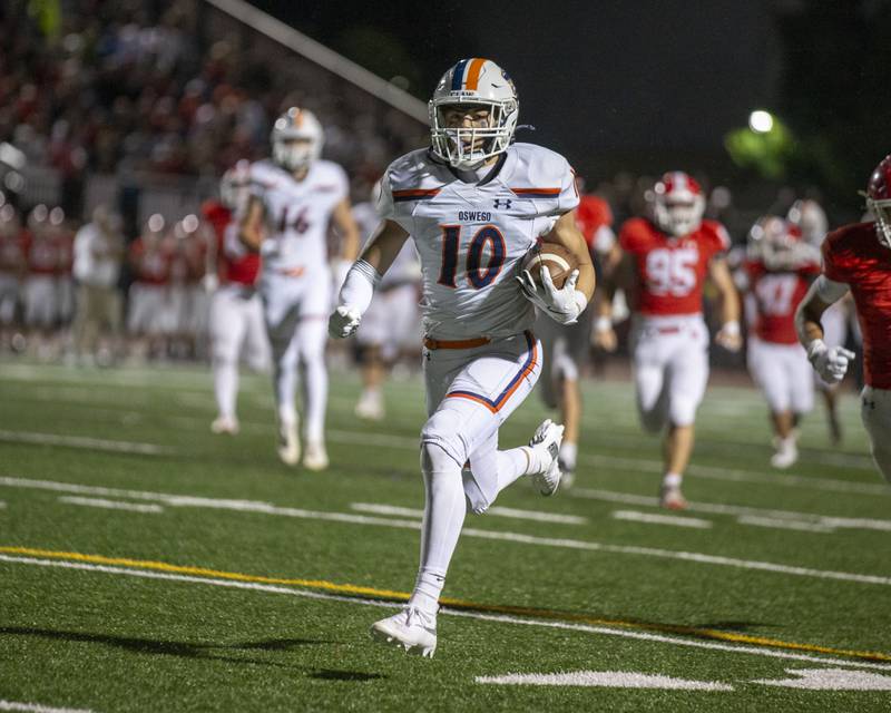 Oswego's Mariano Velasco (10) weaves his way to the endzone after catching a short pass during football game between Oswego at Naperville Central  on Friday, Aug 29, 2025  in Naperville.