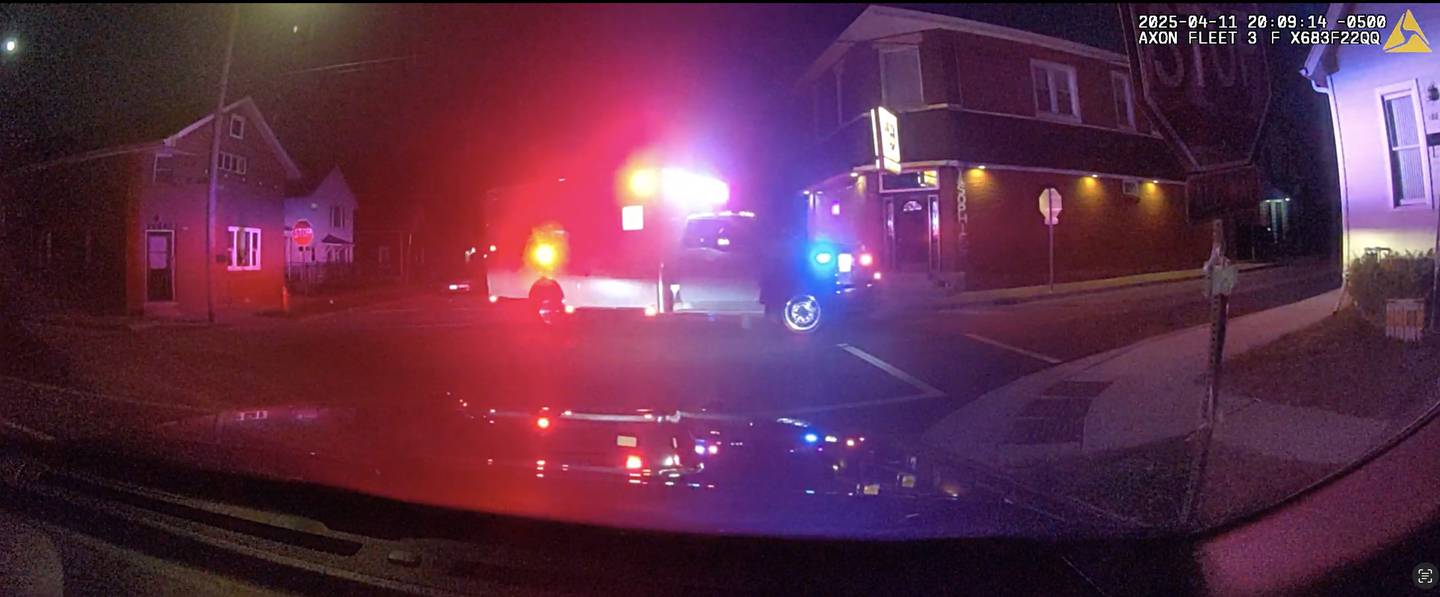 A still from a Joliet Police Department squad vehicle video showing an ambulance on April 11, 2025, leaving the area next to Andy and Sophie's restaurant.