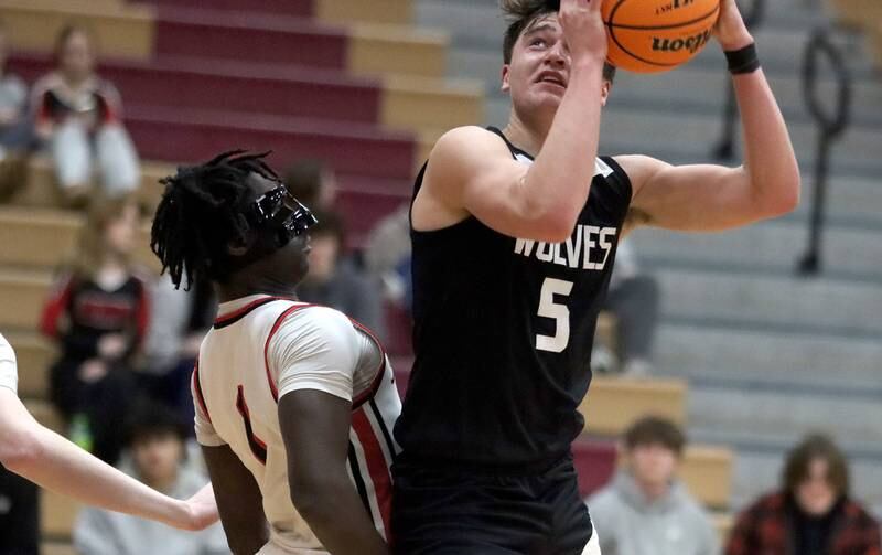 Huntley’s Sheldon Aninagyei Bonsu, left, guards Prairie Ridge’s Eli Loeding in varsity boys basketball on Tuesday, Feb. 18, 2025, at  Huntley High School in Huntley.